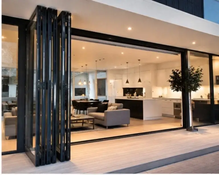 black aluminium bifold doors fully opened to a modern living area